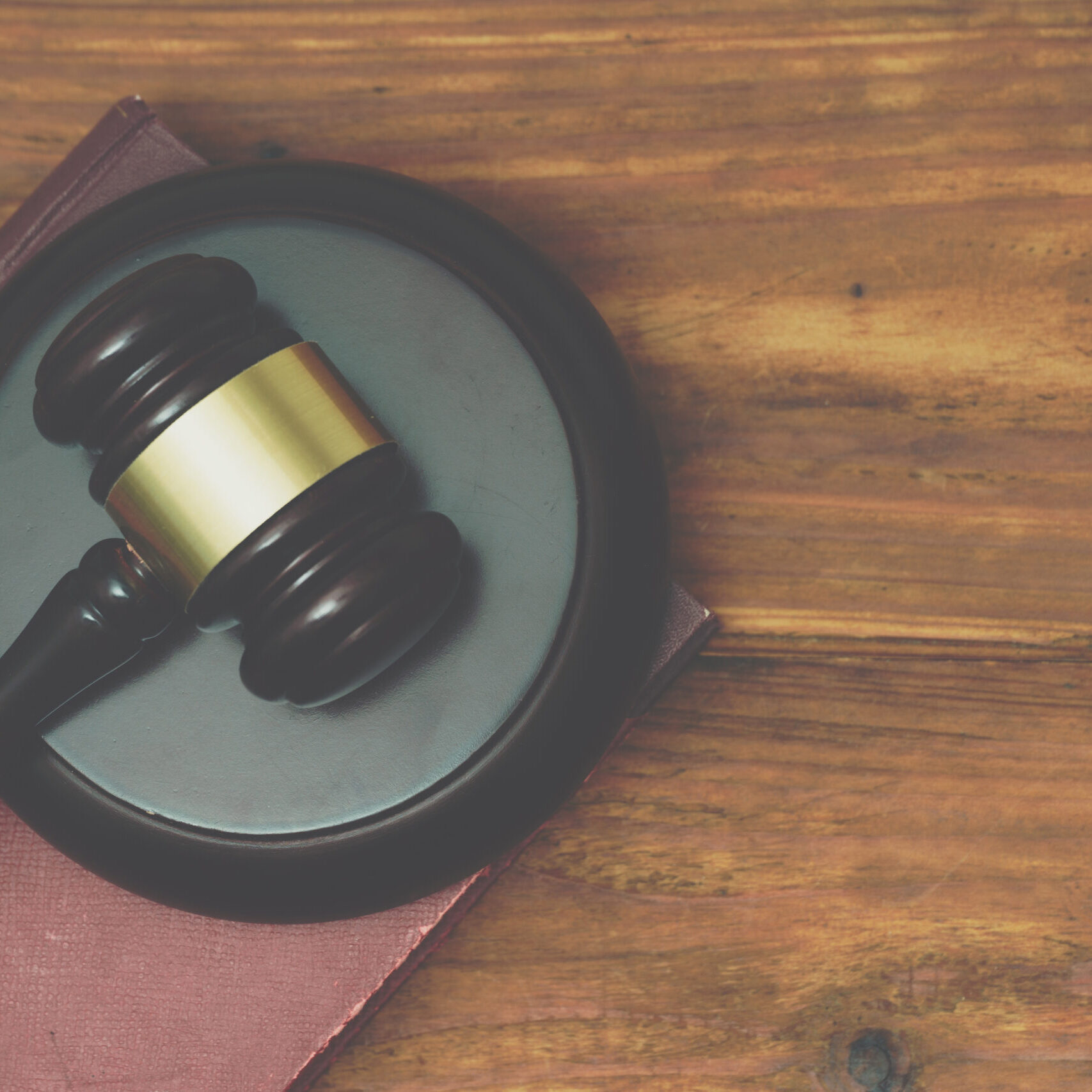 Gavel and law book on a wooden background