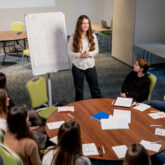 business conference or meeting at the hotel the girl on the flipchart shows the development plan for company