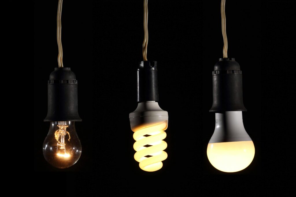 Close-up of incandescent, CFL, and LED bulbs, showcasing the evolution of lighting technology.